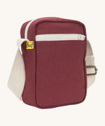 Sleek and compact Fluf Mini Crossbody Bag in burgundy, organic cotton with recycled lining, machine washable, ideal for passports, keys and essentials on the go