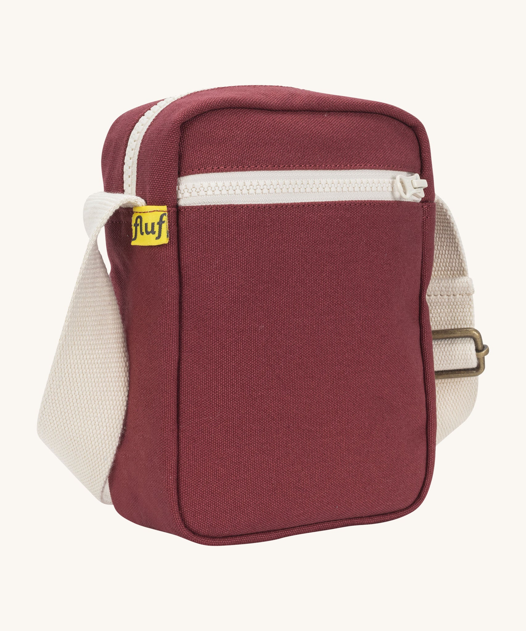 Sleek and compact Fluf Mini Crossbody Bag in burgundy, organic cotton with recycled lining, machine washable, ideal for passports, keys and essentials on the go