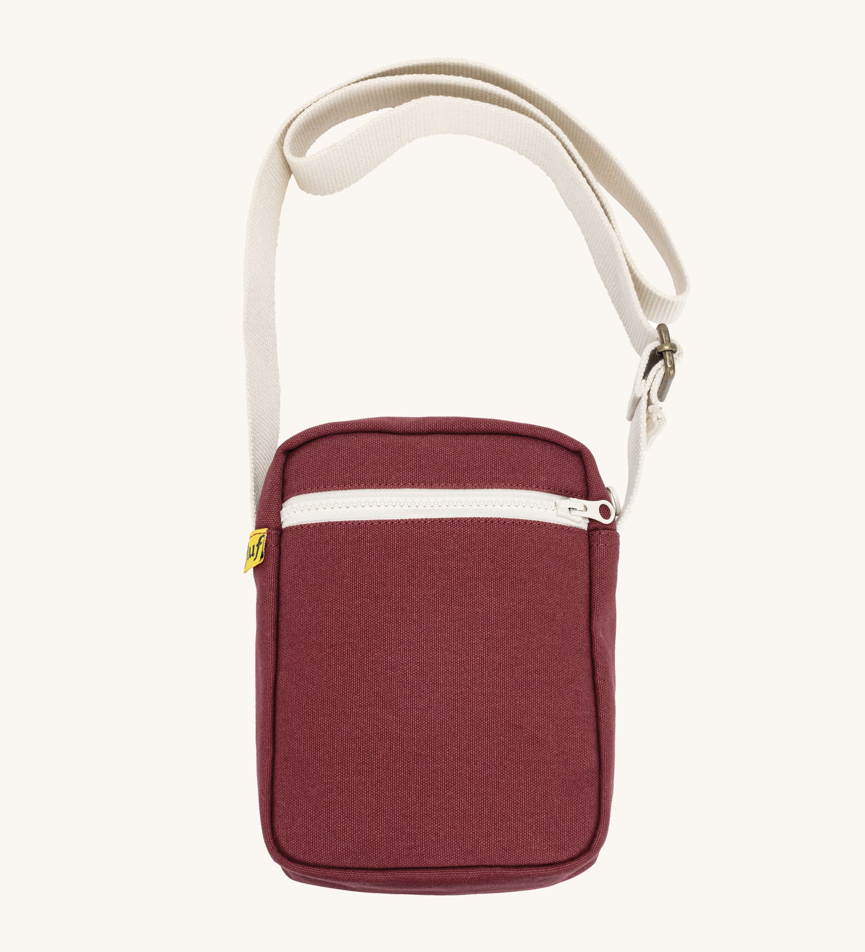 Burgundy Fluf Mini Crossbody Bag made from GOTS certified organic cotton with recycled lining, sporty and stylish travel organiser with front zipper pocket and adjustable shoulder strap