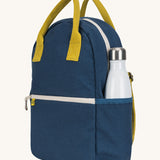 The organic cotton kids Fluf B-Pack Jr in navy blue, the backpack is zipped up and there's a reusable water bottle in the side pocket.