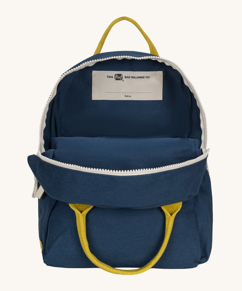 The organic cotton kids Fluf B-Pack Jr in navy blue, the backpack is unzipped.