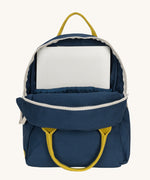 The organic cotton kids Fluf B-Pack Jr in navy blue, the backpack is unzipped and there's a small laptop inside.