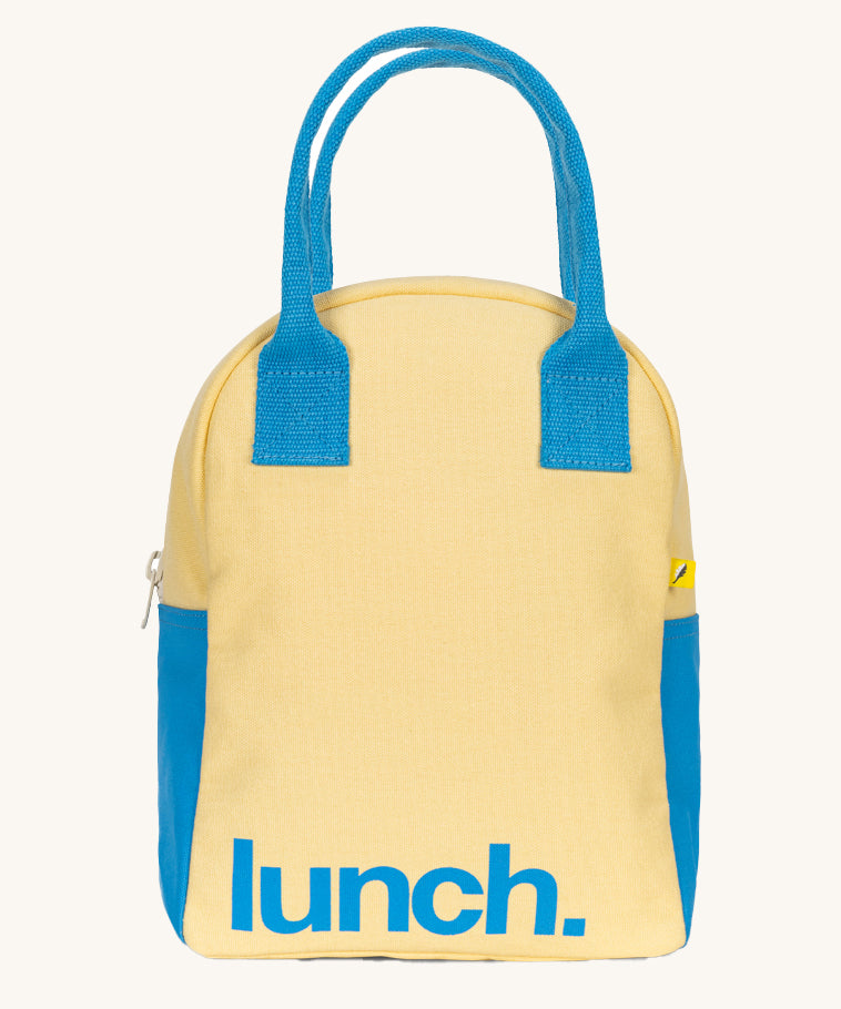 The Fluf organic cotton zippered lunch bag, featuring a blue lunch text design on a light butter yellow background, blue handles and blue side panels