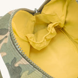 The yellow lined interior of the Fluf organic cotton zippered lunch bag, in a green camo print.