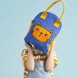 A child holding up the Fluf organic cotton zippered lunch bag, featuring a cat design .
