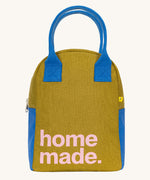 The Fluf organic cotton zippered lunch bag, featuring a home made slogan design on the front, blue handles and blue side panels.