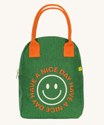 The Fluf organic cotton zippered lunch bag, featuring a emoji design with the words have a nice day on the front, orange handles and green side panels.