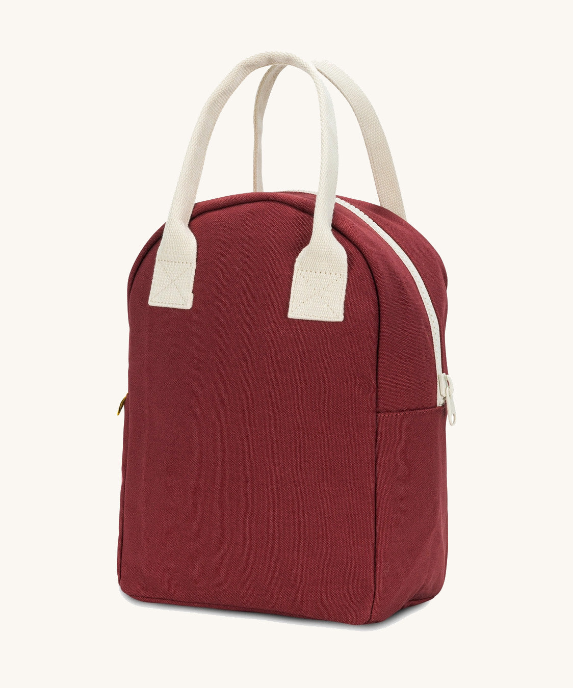 A side view of the Fluf organic cotton zippered lunch bag, in a vintage burgundy colour with a white zip and handles.