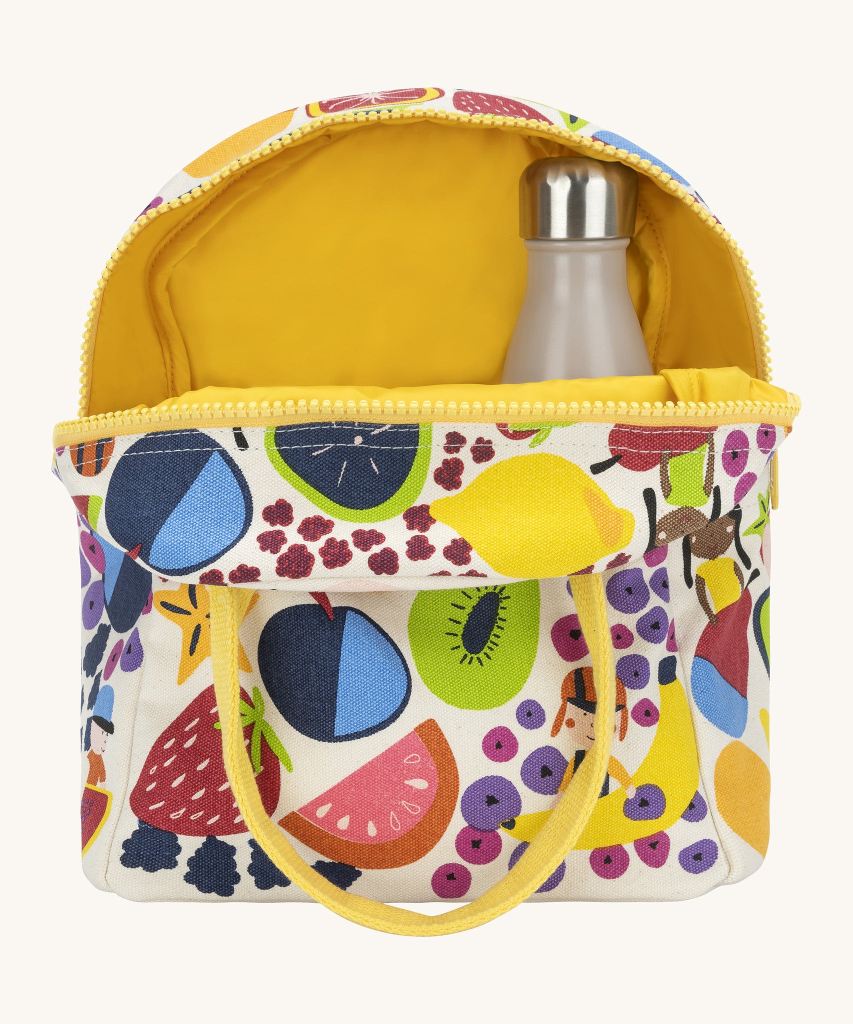 Fluf zip lunch bag in white opened showing the yellow inner lining and a bottle packed inside. Outside of the bag is a design of different coloured fruits with a yellow handle and zip detail on a cream background.