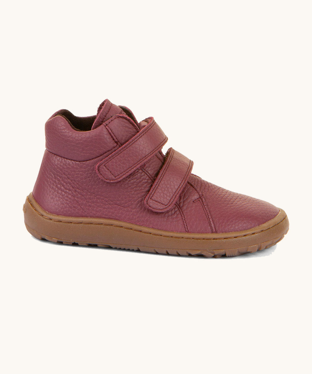 A side image of a Froddo barefoot Autumn children's shoe in bordeaux available at Babipur. A dark purple shoe showing the 2 velcro fastener, padded ankle and the dark brown grippy sole detail