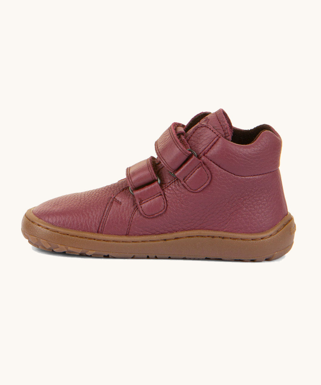 A side image of a Froddo barefoot Autumn children's shoe in bordeaux available at Babipur. A dark purple shoe showing the 2 velcro fastener for a secure fit, padded ankle and the dark brown grippy sole