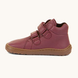 A side image of a Froddo barefoot Autumn children's shoe in bordeaux available at Babipur. A dark purple shoe showing the 2 velcro fastener for a secure fit, padded ankle and the dark brown grippy sole