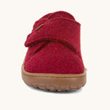 The front of the Froddo barefoot wooly children's shoe in Bordeaux showing the velcro fastener and brown grippy sole detail