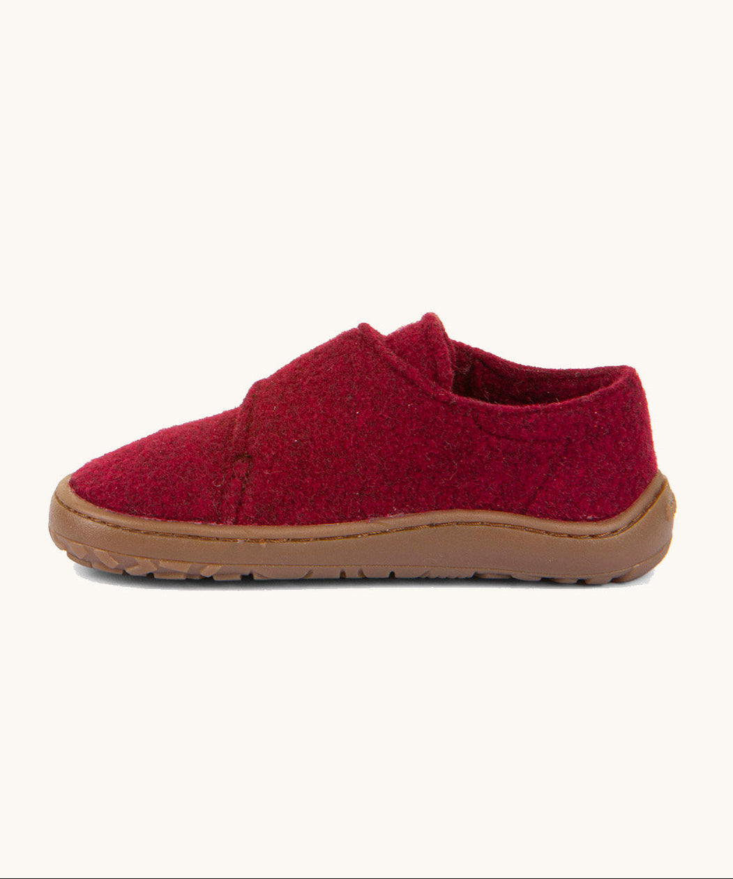 A side image of the Froddo barefoot wooly children's shoe in Bordeaux available at Babipur showing the velcro fastener for a secure fit and a dark brown grippy sole