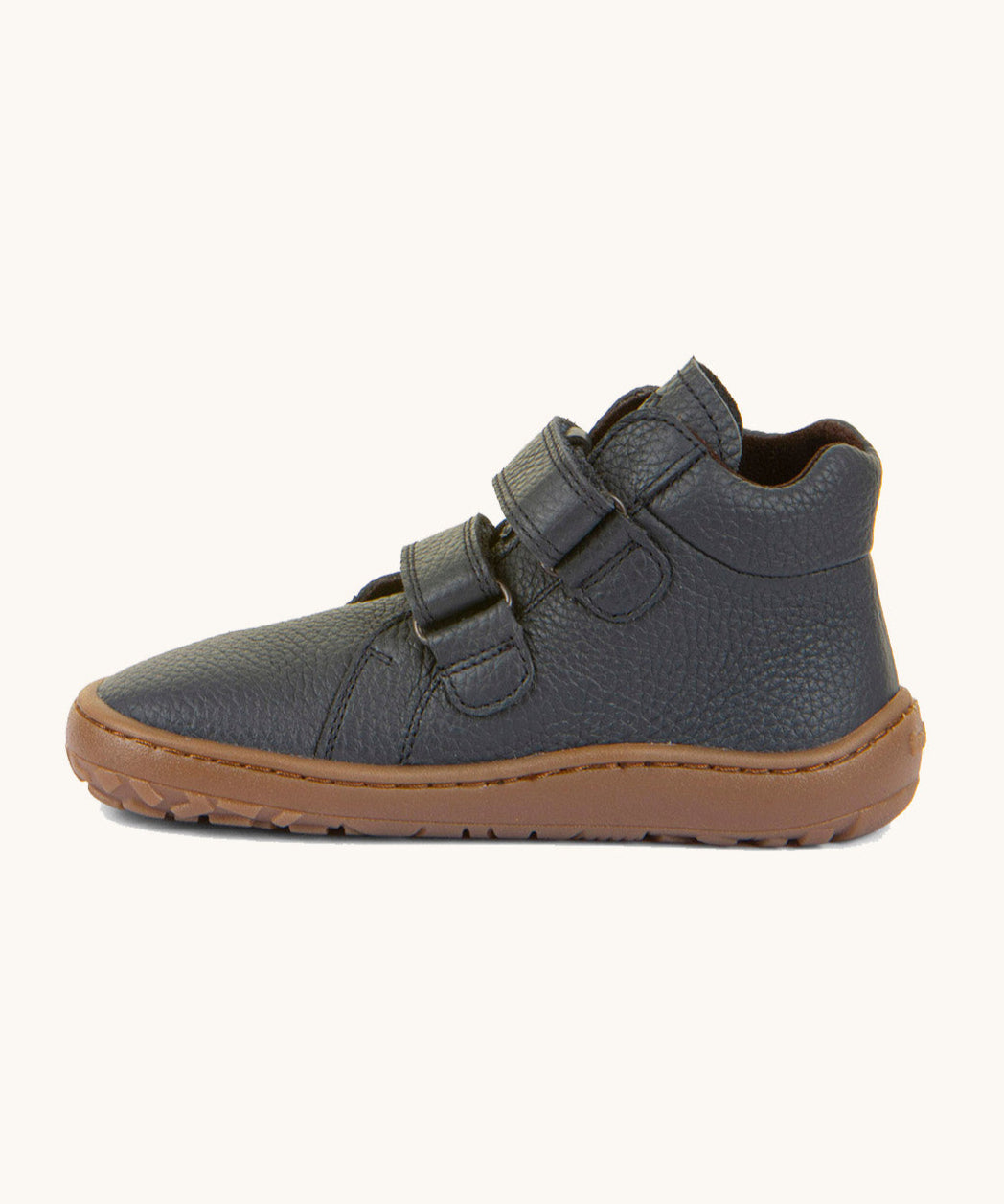 A side image of a Froddo barefoot Autumn children's shoe in dark blue available at Babipur showing the 2 velcro fastener for a secure fit, padded ankle and the dark brown grippy sole