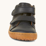 The front of the Froddo barefoot first step baby shoe in dark blue available at Babipur showing the 2 velcro fastener for a secure fit and the grippy sole detail