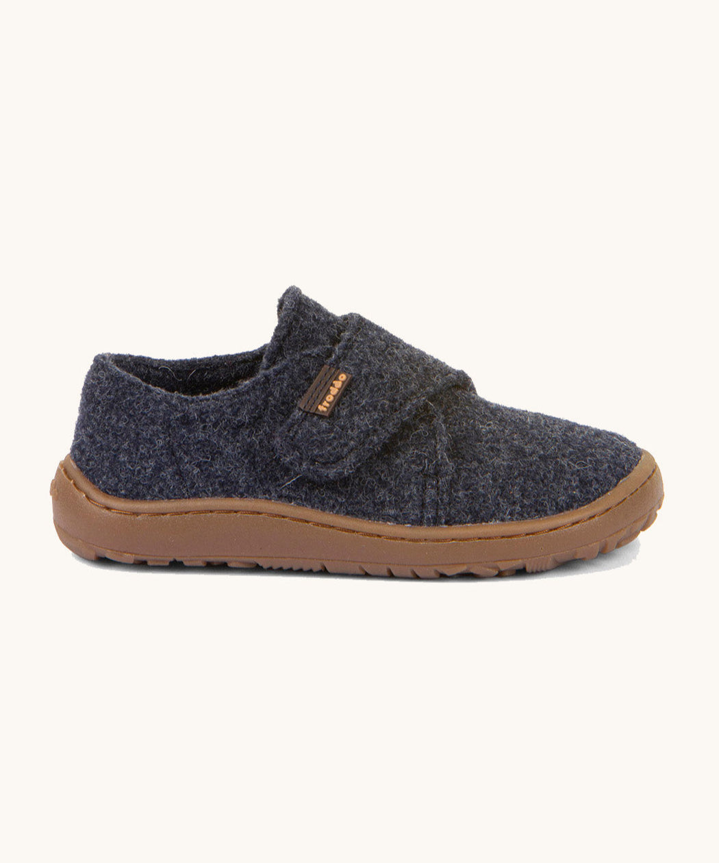 A side image of the Froddo barefoot wooly children's shoe in dark blue available at Babipur showing the velcro fastener dark brown grippy sole detail