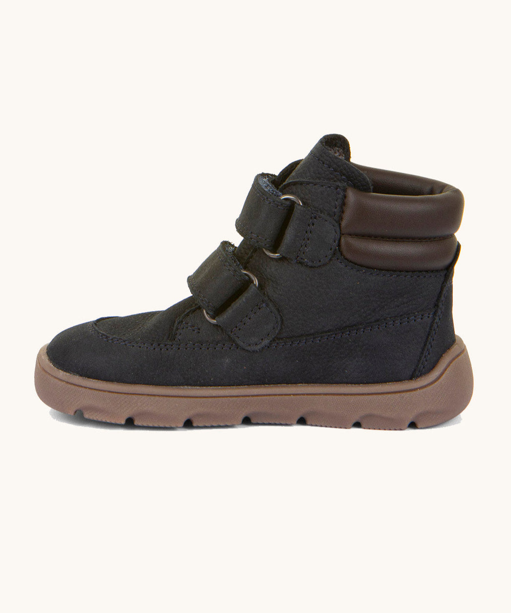 A side image of the Froddo barefoot Zuru tex children's shoe in dark blue available at Babipur showing the 2 velcro fasteners, padded ankle support and the dark brown grippy sole detail