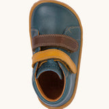 A top down image of the Froddo barefoot first step baby shoe in dark denim available at Babipur showing the 2 velcro fasteners and inner sole detail