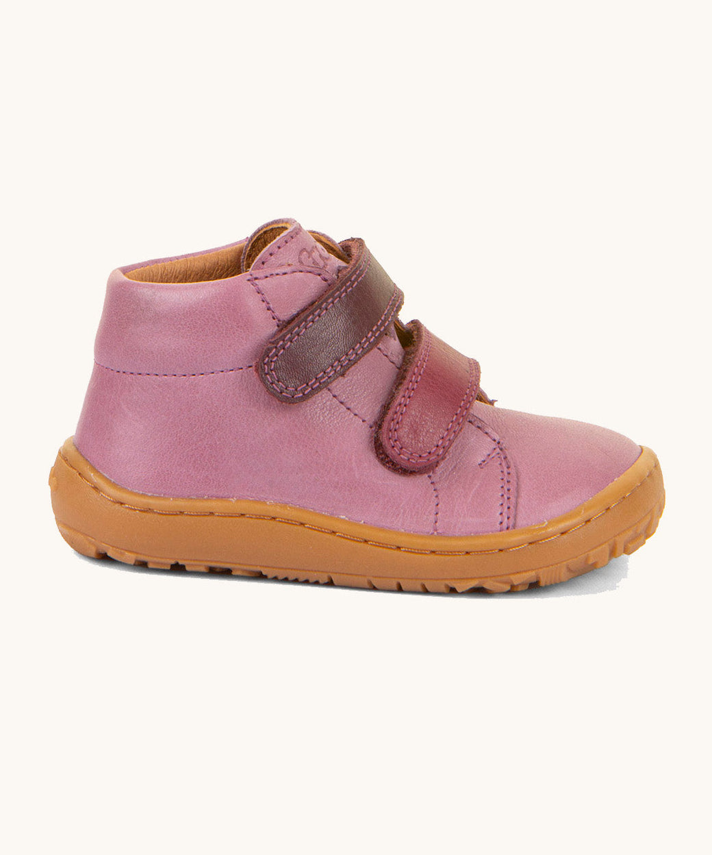 A side image of the Froddo barefoot first step baby shoe in pink available at Babipur. Showing the velcro fasteners and padded ankle detail
