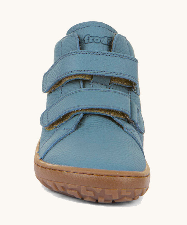 The front of the Froddo barefoot Autumn children's shoe in light blue denim colour available at Babipur showing the 2 velcro fastener detail