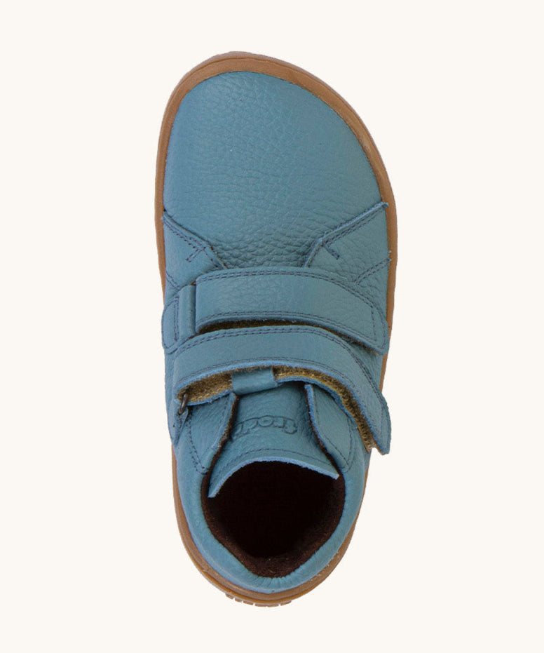 A top down image of a Froddo barefoot Autumn children's shoe in light blue denim colour available at Babipur showing the 2 velcro fastener for a secure fit and insole detail.