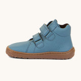 A side image of a Froddo barefoot Autumn children's shoe in light blue jeans colour available at Babipur showing the 2 velcro fastener for a secure fit, padded ankle and the dark brown grippy sole