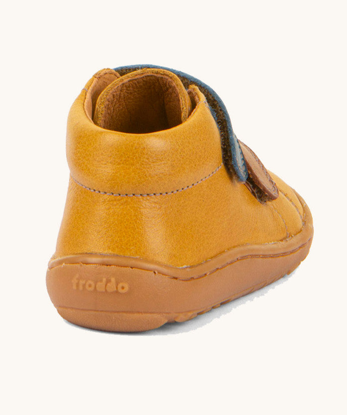 The back of the Froddo barefoot first step baby shoe in mustard available at Babipur showing padded ankle support and brown grippy sole detail