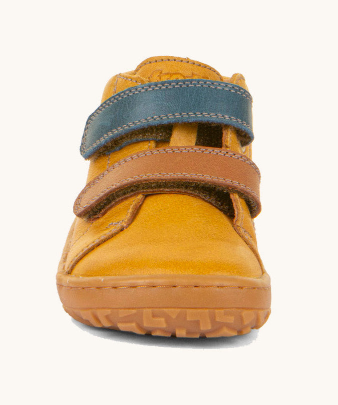 The front of the Froddo barefoot first step baby shoe in mustard available at Babipur showing the 2 velcro fasteners and grippy sole detail