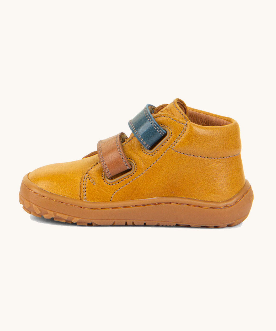Froddo barefoot first step baby shoe in mustard available at Babipur showing the 2 velcro fastener for a secure fit in blue and brown and the grippy sole