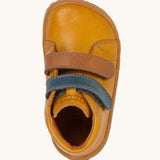 A top down image of the Froddo barefoot first step baby shoe in msutard available at Babipur showing the 2 velcro fasteners and inner sole detail