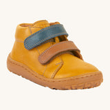 Froddo barefoot first step baby shoe in mustard. A dark yellow natural leather shoe with a 2 velcro fastener for a secure fit in blue and brown and a grippy sole
