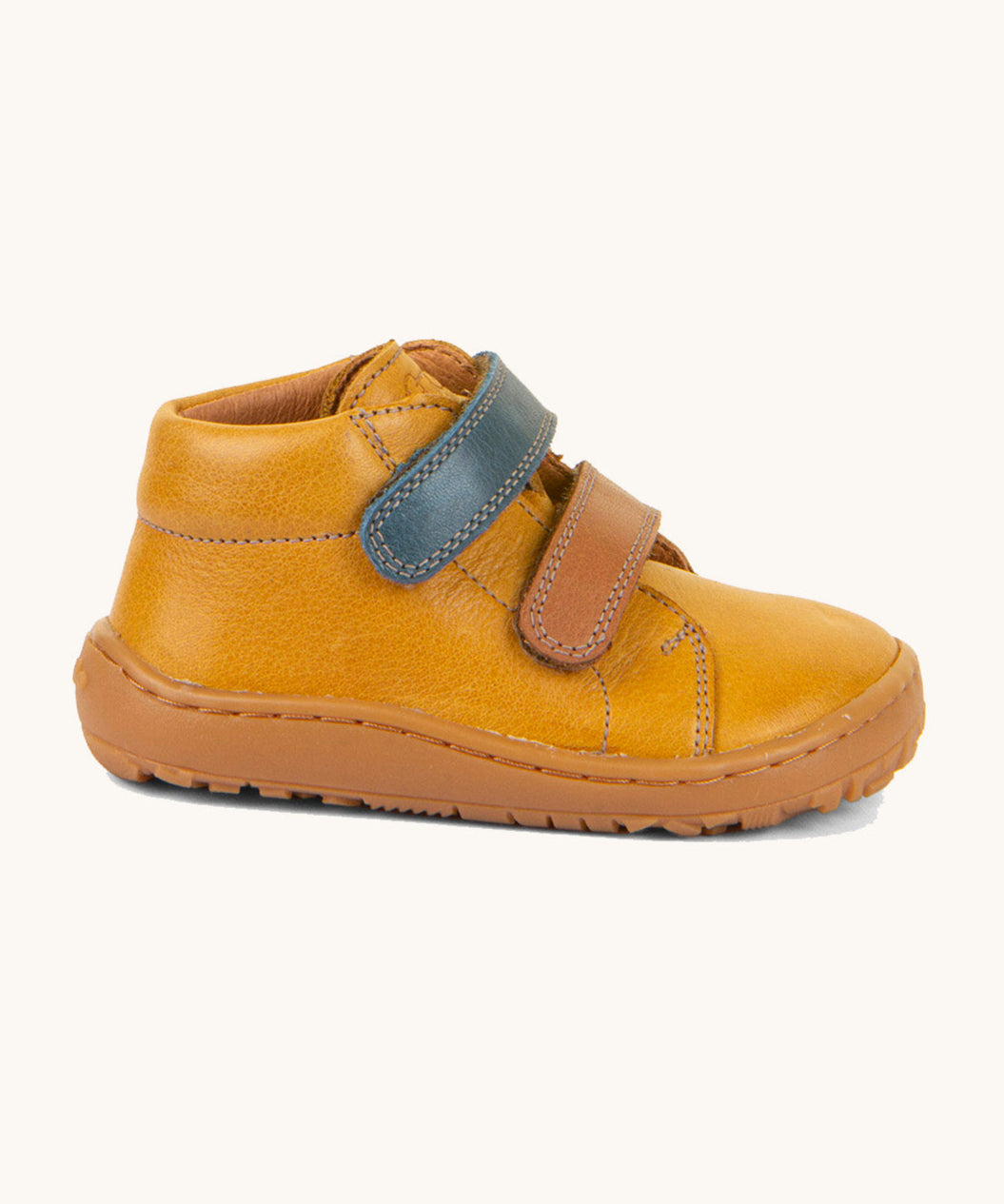 A side image of the Froddo barefoot first step baby shoe in mustard available at Babipur showing the 2 velcro fastener and padded ankle support detail
