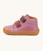 A side image of the Froddo barefoot first step baby shoe in pink available at Babipur. Showing the 2 darker pink velcro fastener for a secure fit and the light brown grippy sole