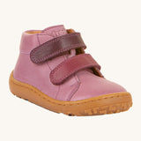 Froddo barefoot first step baby shoe in pink. A natural leather shoe with a 2 darker pink velcro fastener for a secure fit and a light brown grippy sole