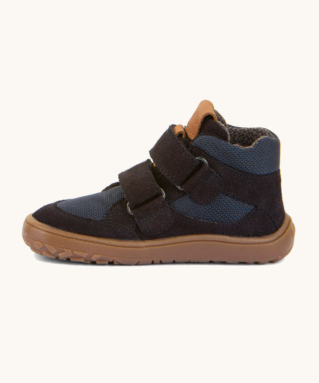 A side image of the Froddo barefoot Tex Autumn children's shoe in navy available at Babipur showing 2 velcro fasteners on the front, padded ankle support and a brown grippy sole.