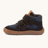 A side image of the Froddo barefoot Tex Autumn children's shoe in navy available at Babipur showing 2 velcro fasteners on the front, padded ankle support and a brown grippy sole.