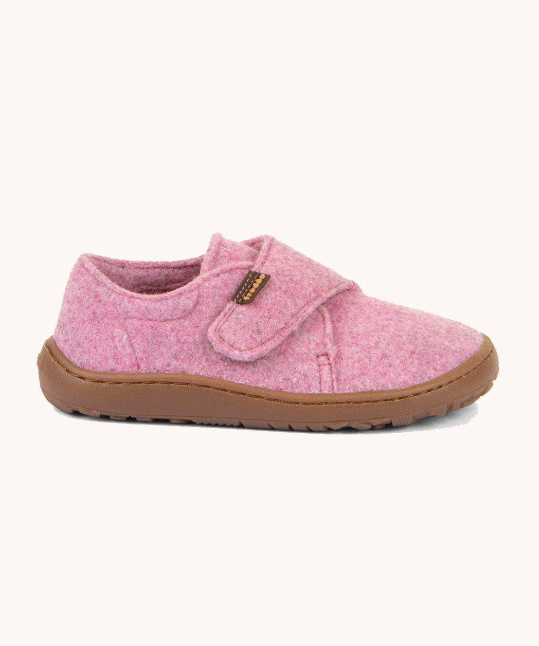 A side image of the Froddo barefoot wooly children's shoe in pink available at Babipur showing the velcro fastener for a secure fit and a dark brown grippy sole