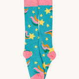 A close up of the rainbow Frugi brilliant boot sock showing the yellow star print and pink toe and heel detail on light blue organic cotton fabric