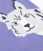 A close up of the snow leopard applique on the Frugi Adventure big cats Applique organic cotton long sleeved top. This top features three big cat appliques on a grape purple coloured background. This top is a part of a wide range of organic cotton clothing for children available here at Babipur.