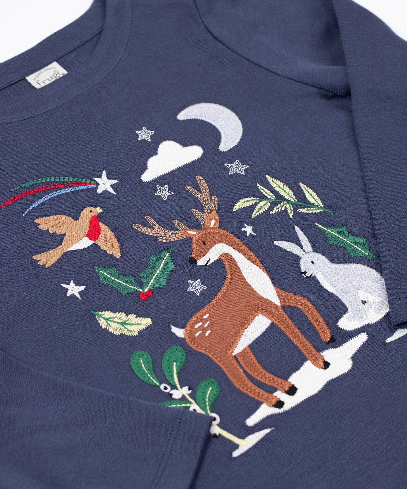 A close up of the reindeer designon the front of the Frugi navy reindeer applique  Organic Cotton Anna long sleeved Top. This top is a part of a wide range of organic cotton clothing for children available here at Babipur.