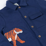 A close up of the orange tiger applique on the side of the Frugi Big Cats Navy Organic Cotton Cosy Kids' Shirt Shaket. This shaket has a tiger and cheetah applique details on the sides. This navy shirt jacket is a part of a wide range of organic cotton clothing for children available here at Babipur.