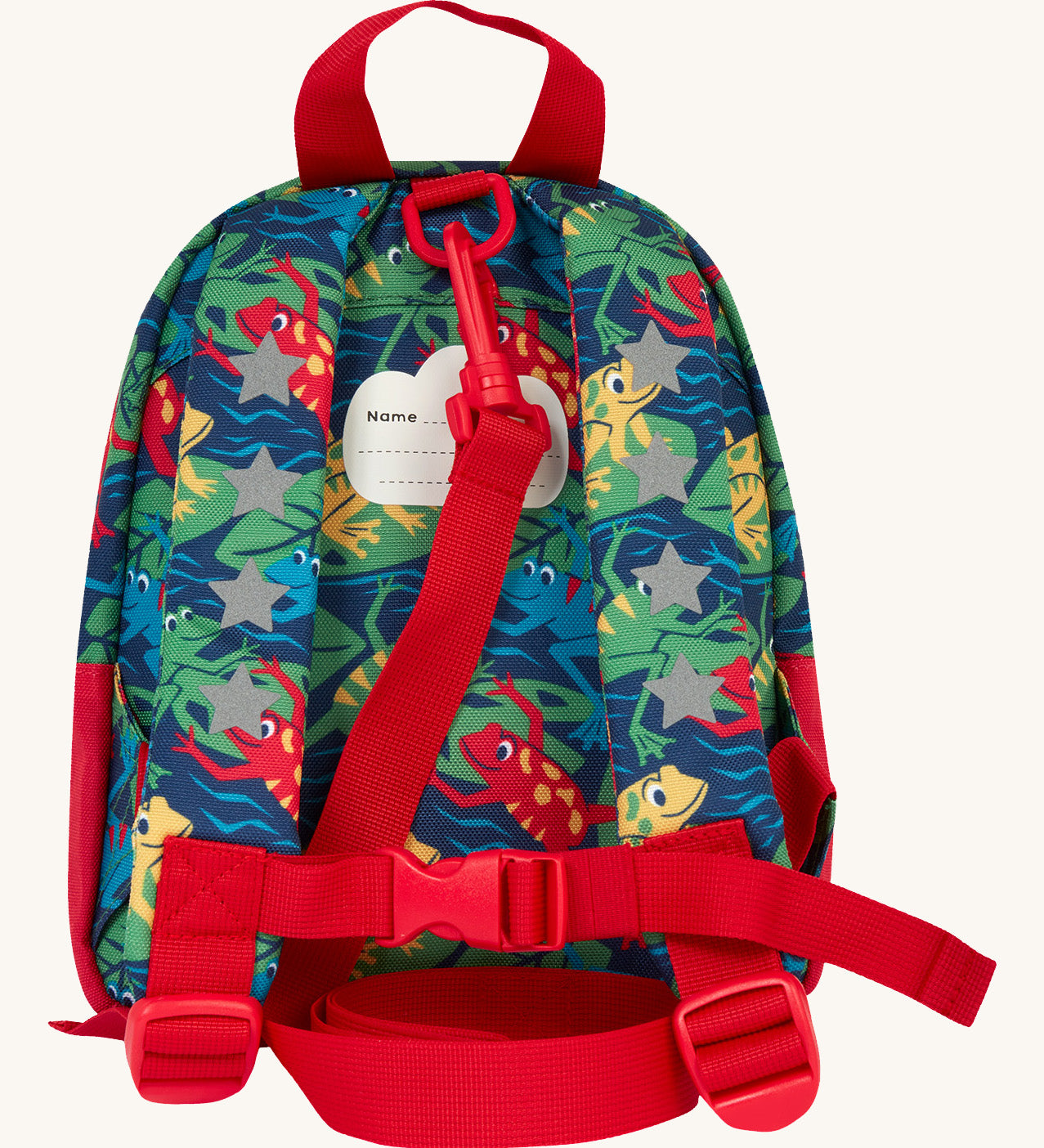The back of the Frugi little adventures be hoppy backpack showing the reflective stars on the shoulder straps and the red rein clipped to the top of the bag