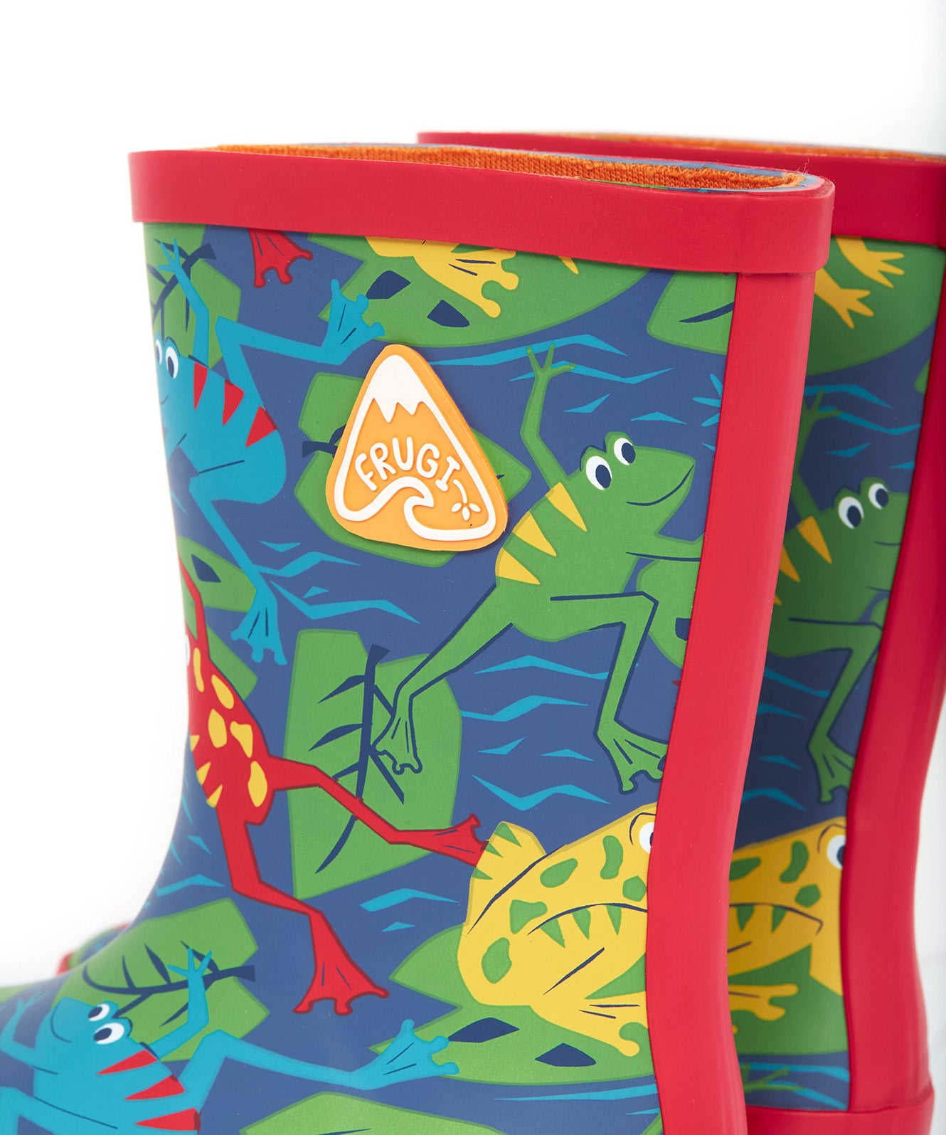 A close up of the top of the Frugi kids puddle buster wellington boots. Showing the the red trim and frog print detail on navy natural rubber material. Features a yellow triangular brand patch on the outside of the boot.