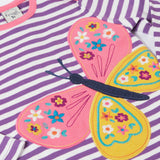 A close up of the butterfly applique detail on the front of the Frugi Children's organic cotton Bobby butterfly Applique purple striped  long sleeved Top. The top has a violet purple and white stripe background with a large decorated butterfly applique on the front. This top is a part of a wide range of organic cotton clothing for children available here at Babipur.