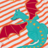 A close up of the Dragon applique on the Frugi Children's Bobby dragon Applique orange and white striped long sleeved Top. This top is a part of a wide range of organic cotton clothing for children available here at Babipur.