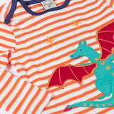 A close up of the Dragon applique on the Frugi Children's Bobby dragon Applique orange and white striped long sleeved Top. This top is a part of a wide range of organic cotton clothing for children available here at Babipur.