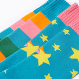 A close up of the Frugi 2 pack rainbow brilliant boot socks showing the print and cuff detail on organic cotton fabric