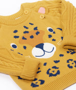 A close up of the leopard's face on the Frugi Caleb leopard Character Knit Organic Cotton Kids' Jumper. This knitted jumper is a part of a wide range of organic cotton clothing for children available here at Babipur.