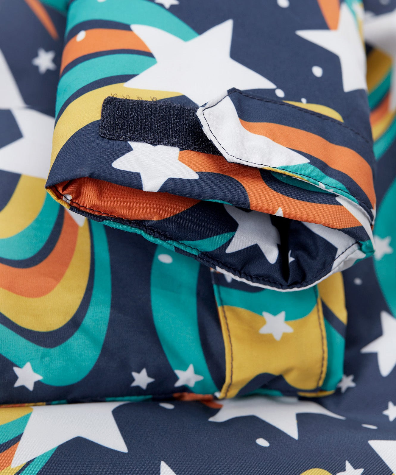 A close up of the arm cuff on the Frugi playtime magic stars coat showing the velcro detail for size adjusting.